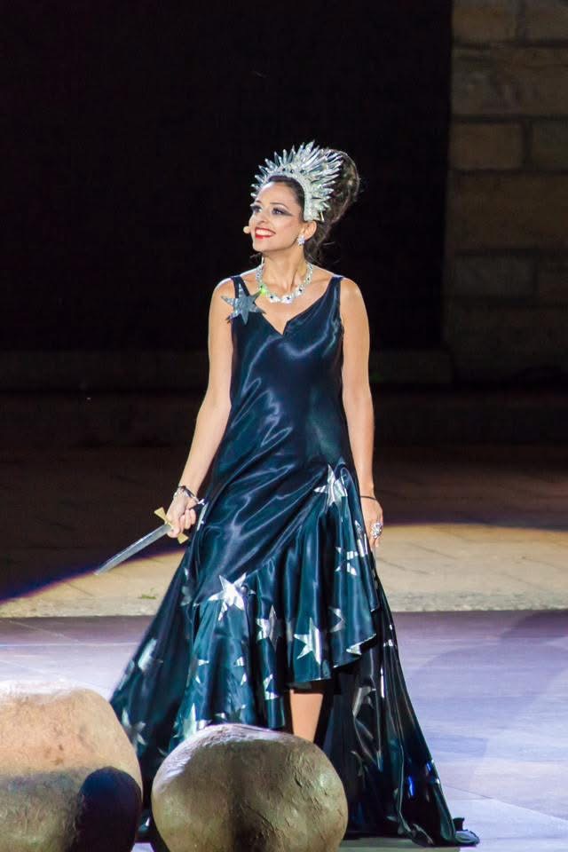 Hila Fahima as the Queen of the Night on stage in a midnight gown with silver stars, holding a dagger