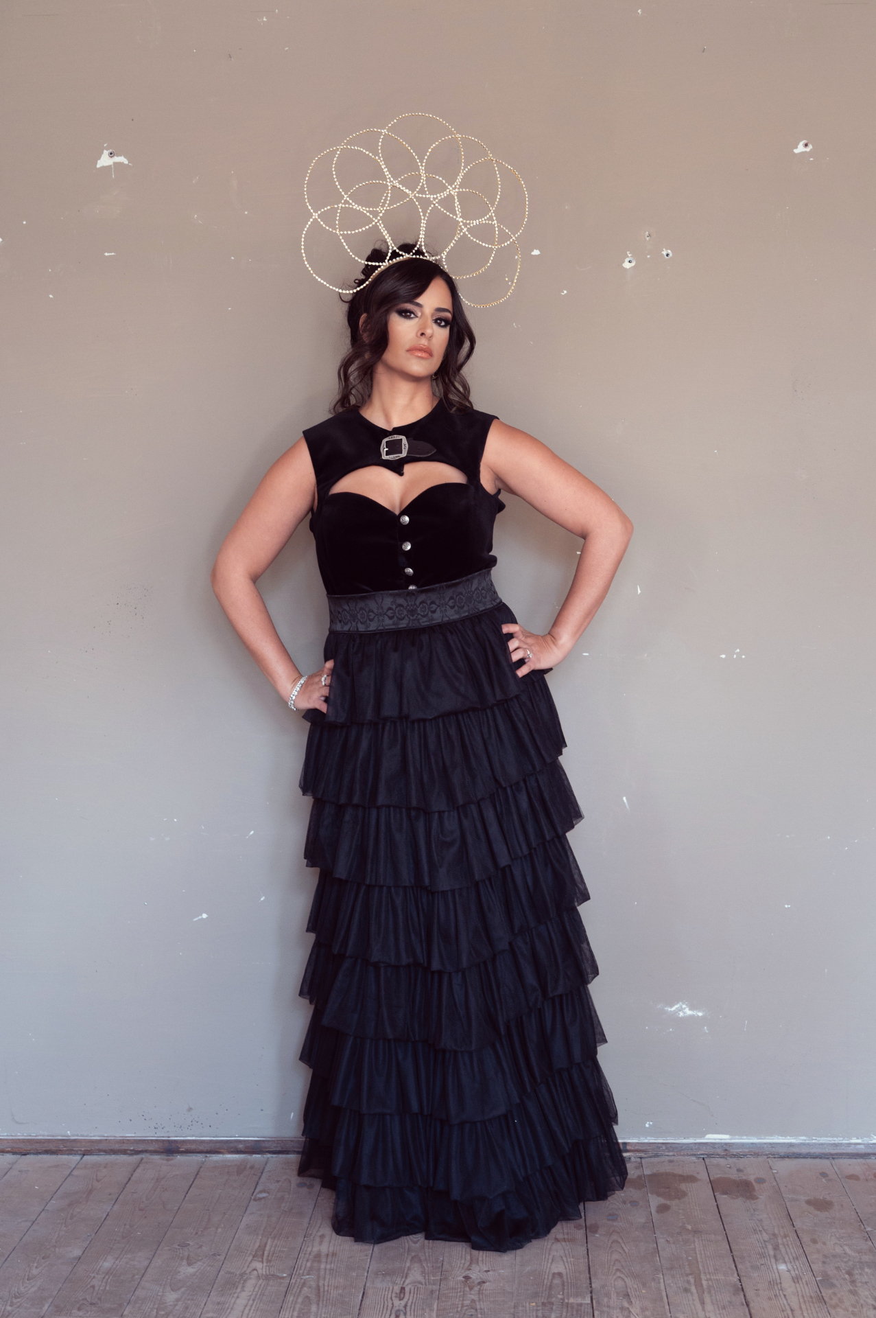 Hila Fahima in a black ruffled gown with a crystal halo crown, by Manfred Baumann, 2025