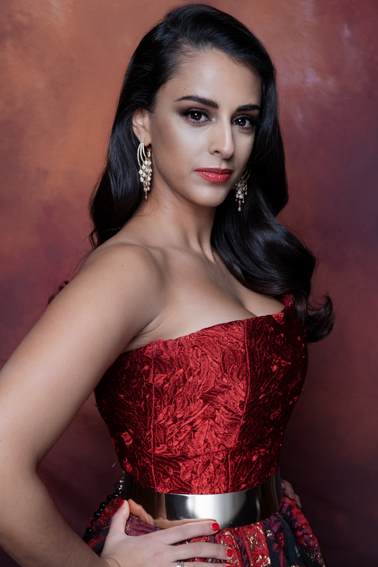 Hila Fahima in a red brocade gown, portrait by Manfred Baumann