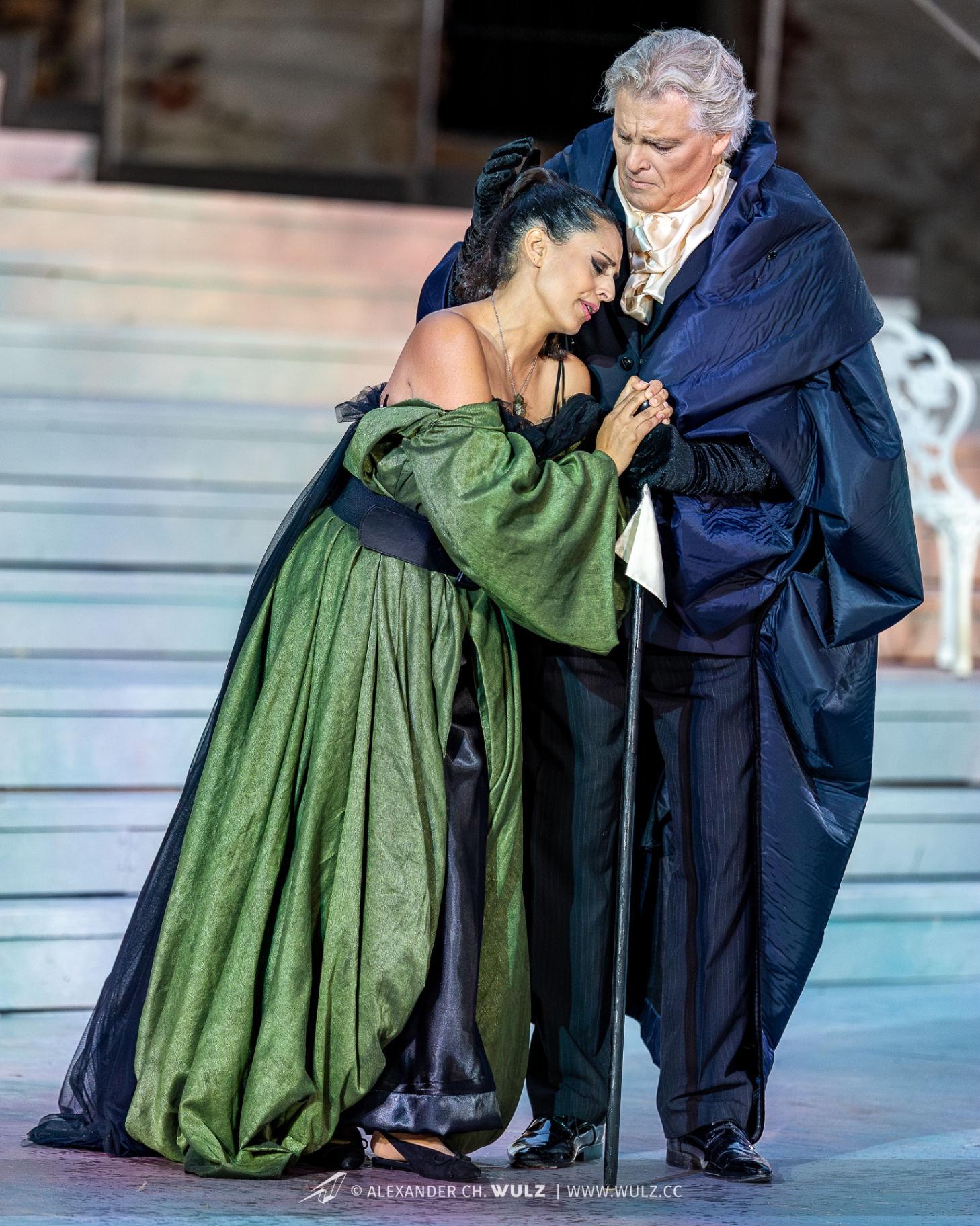 Hila Fahima as Violetta in La traviata, Oper Burg Gars 2025 — leaning on Germont in an olive gown, photo by Alexander Wulz