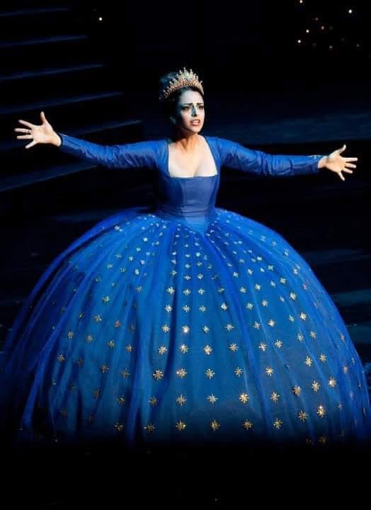 Hila Fahima as the Queen of the Night in a star-strewn blue gown with a crown